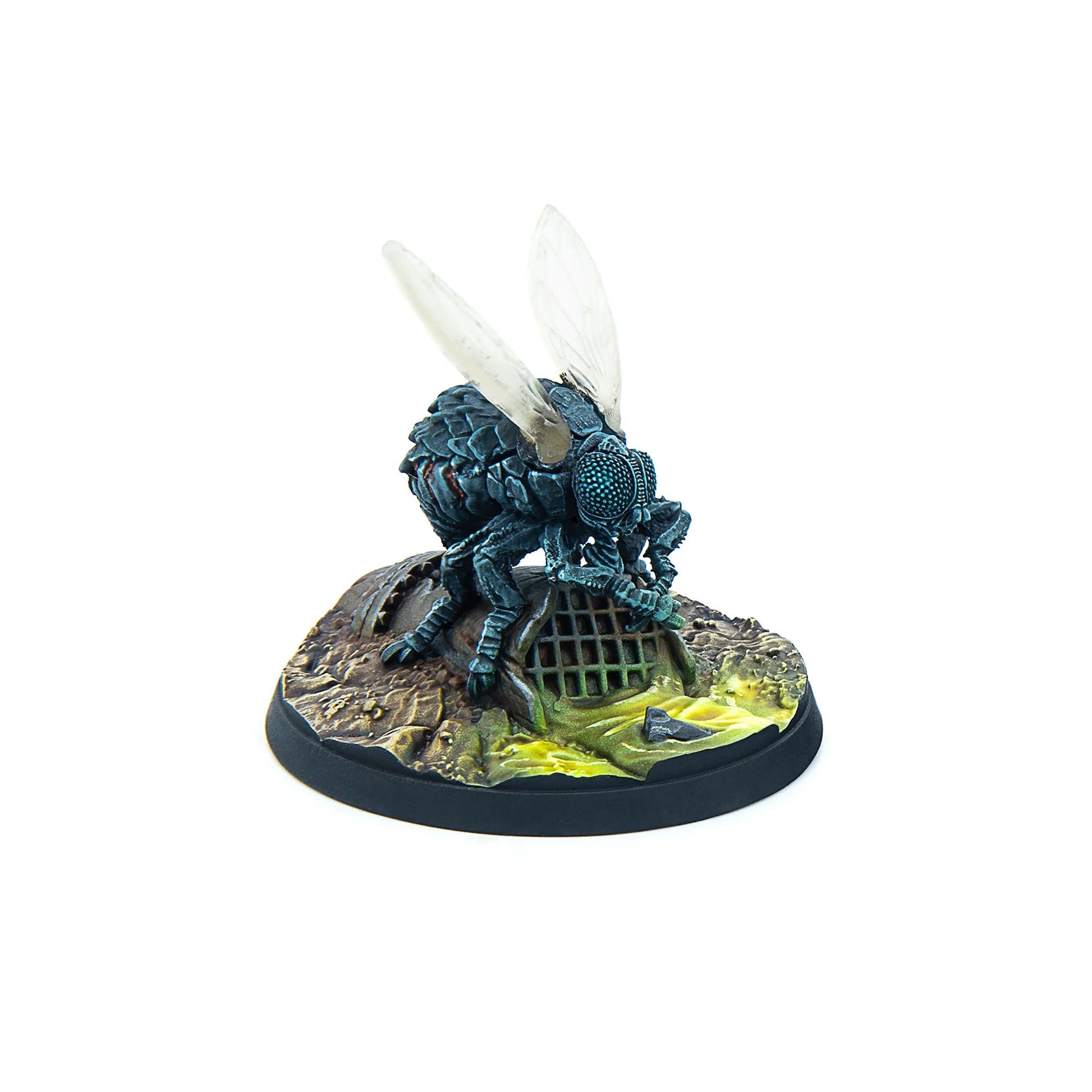 A detailed miniature of a dark fly with clear wings, standing on a base with a gridded drain and glowing green liquid