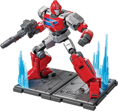 Red and gray robot action figure holding a rifle, posed on a gray display base with blue energy spikes
