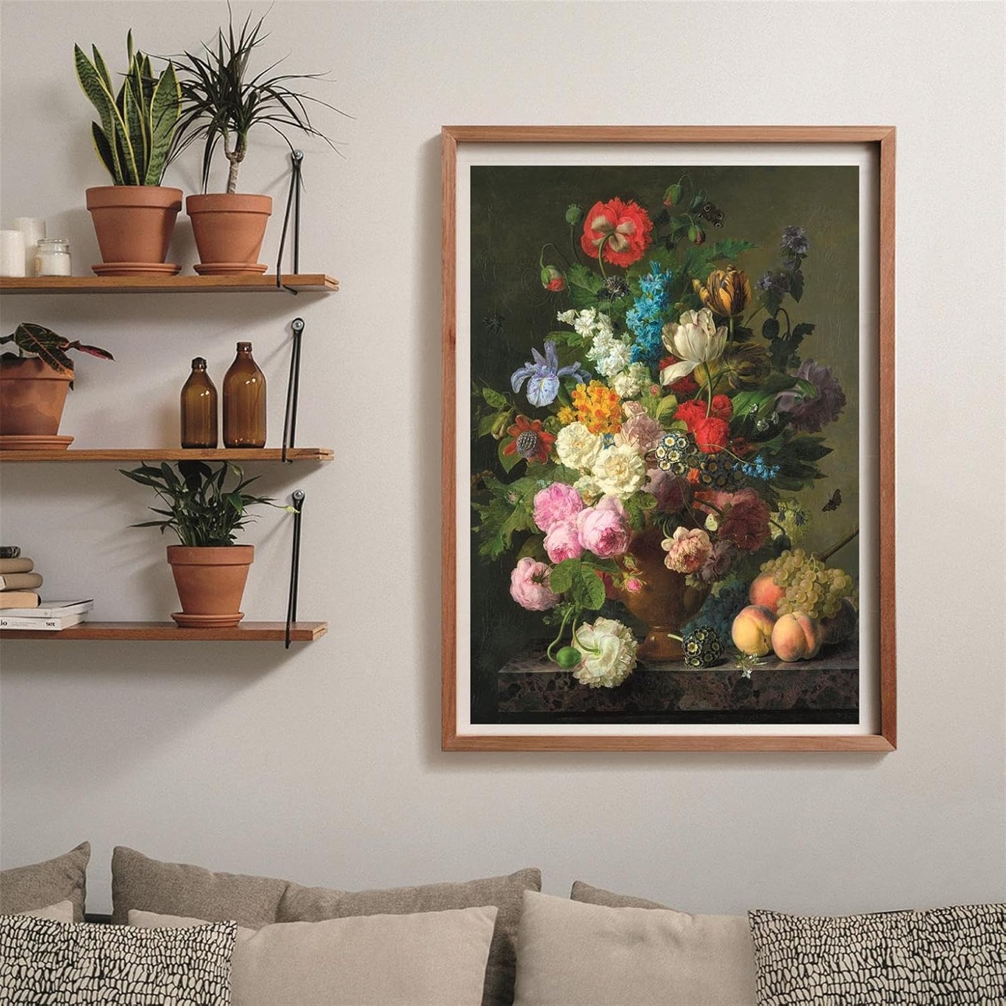 A framed classical still life painting features a vibrant bouquet of colorful flowers in a vase, with fruit