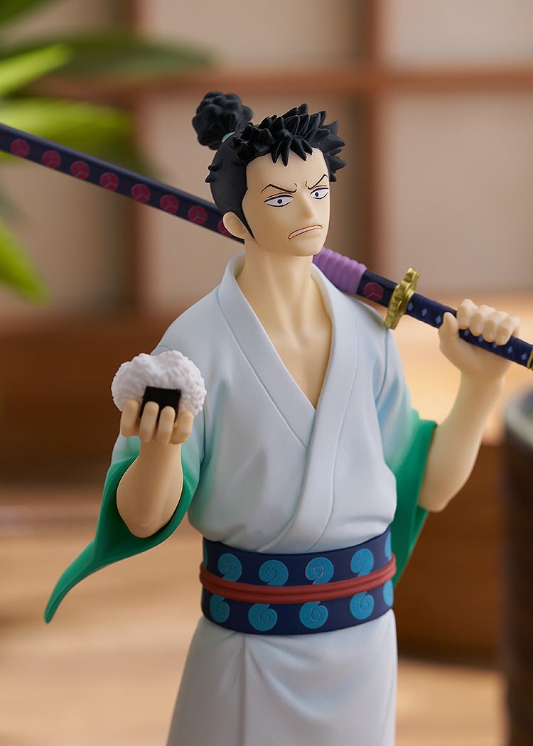 Anime figure of a man in a light blue kimono, sternly holding a katana over his shoulder and an onigiri