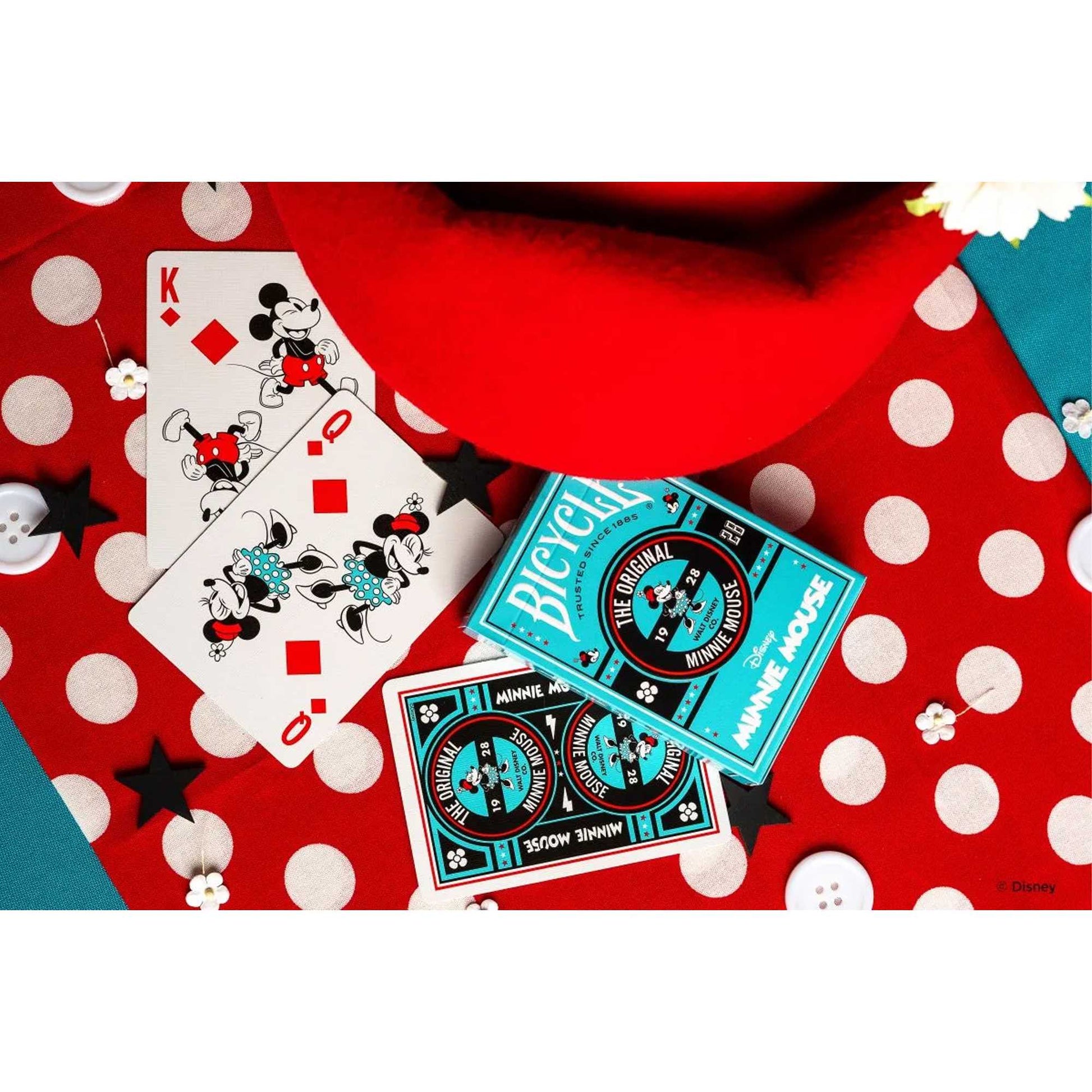 Bicycle Disney Minnie Mouse playing cards and box on a red polka dot surface