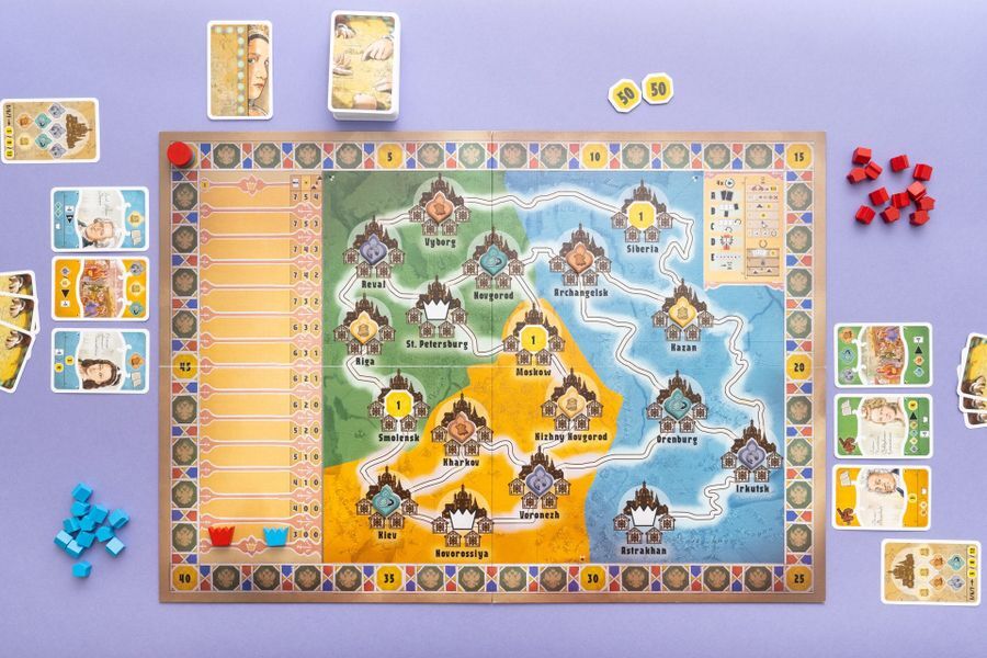 Catherine The Cities of the Tsarina board game with cards tokens and game pieces on a purple background