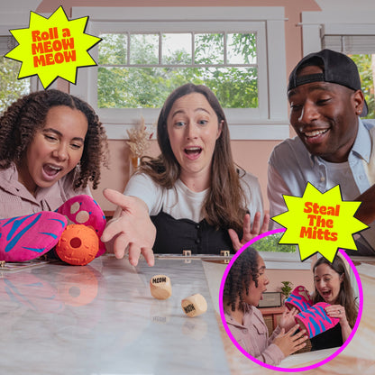 Three excited friends play a game the central woman rolls "MEOW" dice inset shows two women laughing over pink mitts