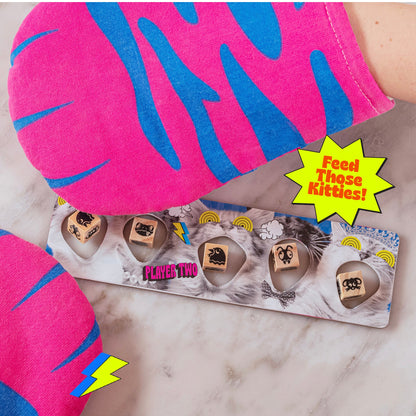 A vibrant "Feed Those Kitties" board game shows cat faces wooden pieces and pink & blue patterned fabric "Player Two" is visible
