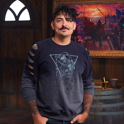 A smiling man with a mustache, curly hair, and arm tattoos, in a graphic ombre sweatshirt. A dramatic painting is behind him