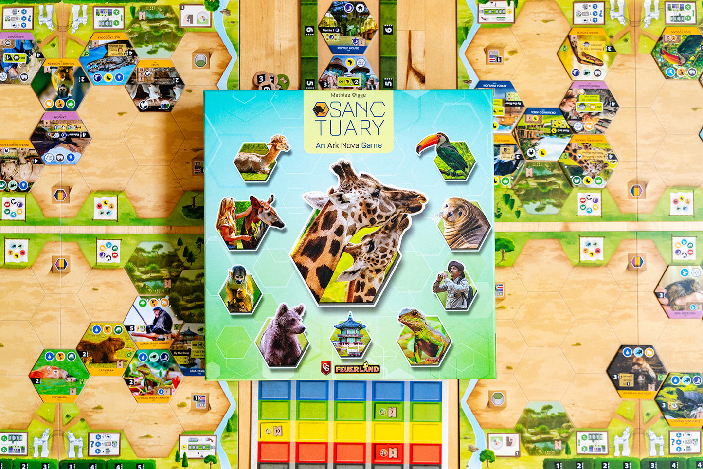 Sanctuary: An Ark Nova Game box, featuring giraffes and diverse wildlife, placed on the hexagonal game board