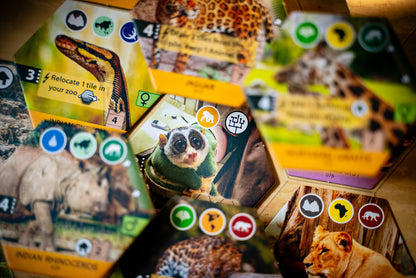 Close-up of hexagonal animal tiles from a board game, with the central tile showing a slow loris