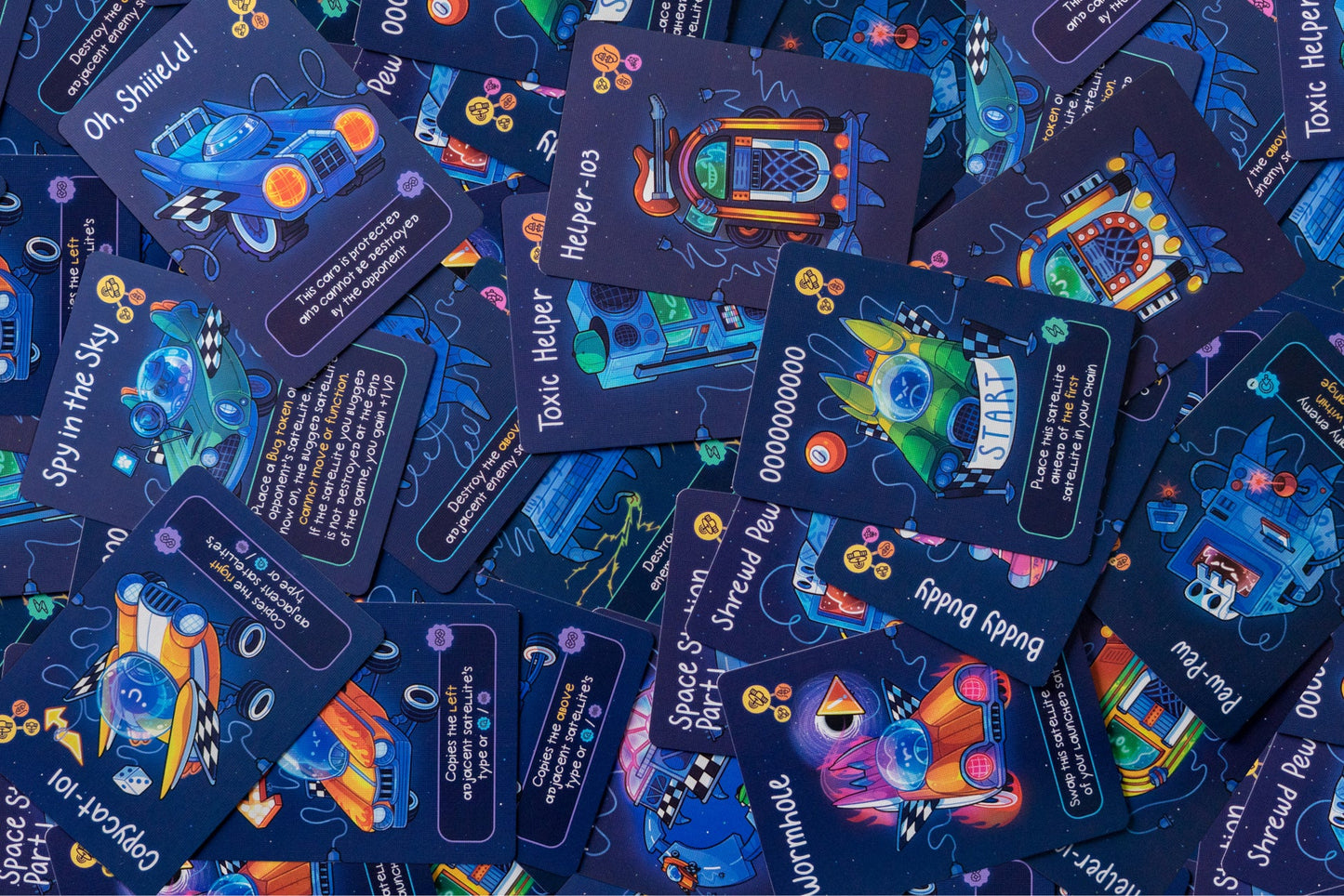 A pile of vibrant, sci-fi themed game cards, depicting space vehicles and robots, spread across a table