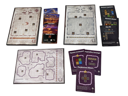 The Cartographers Map Pack Collection laid out, featuring three unique gridded map sheets and multiple stacks of thematic game cards for diverse gameplay