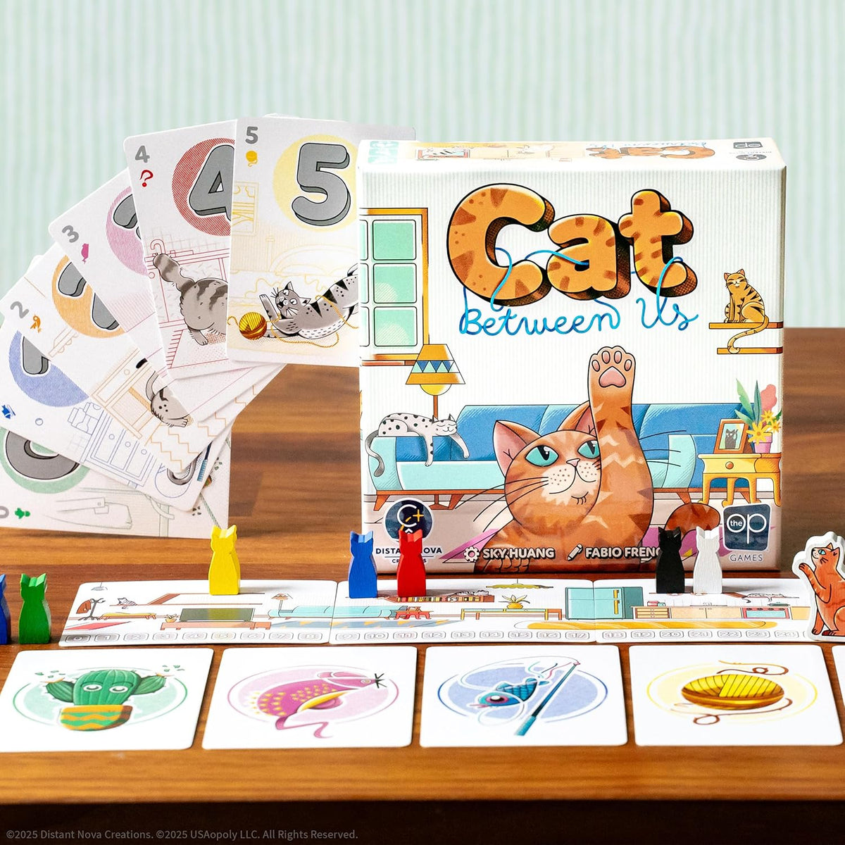 Cat Between Us board game setup, showing the box art, play track, number cards, and cat-shaped meeples