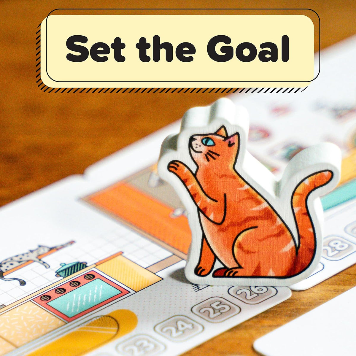 Wooden orange cat meeple standing on a numbered game board track. Title reads, &quot;Set the Goal&quot;