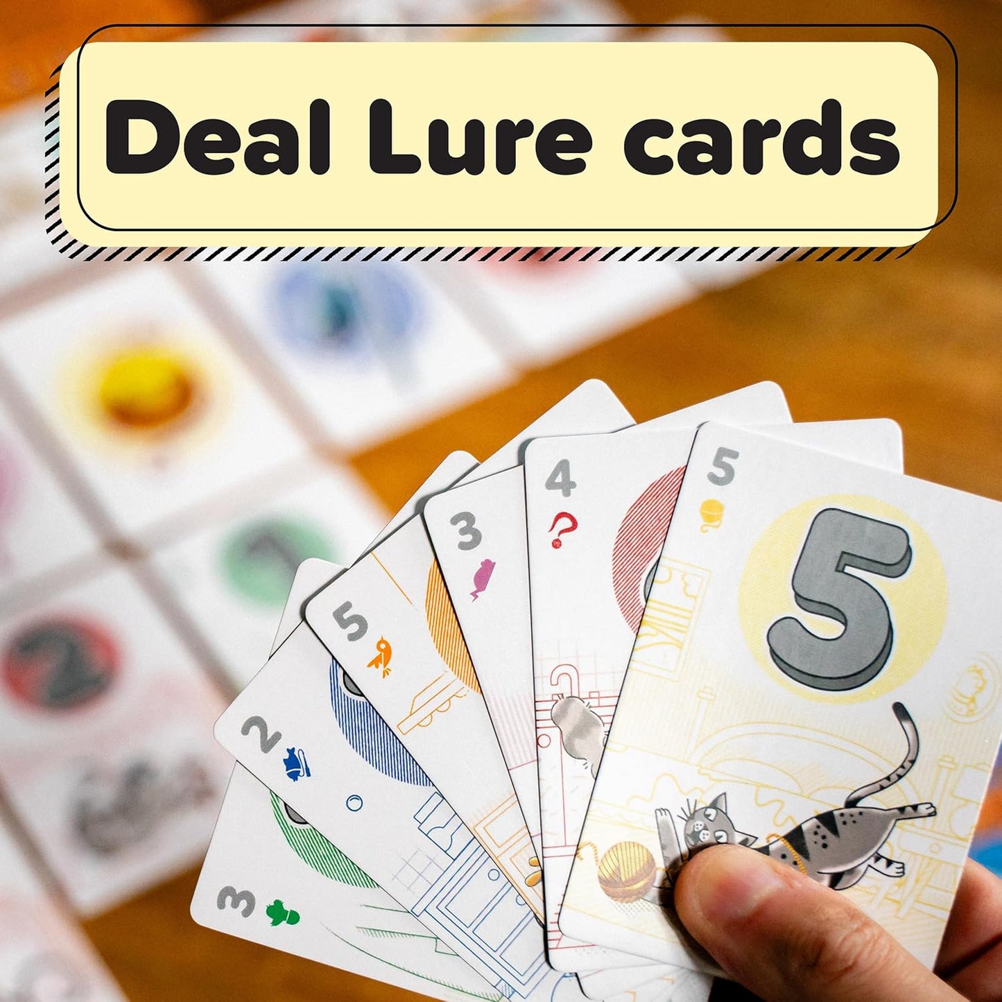 Hand holding a fan of numbered game cards, overlaid with the text: "Deal Lure cards"