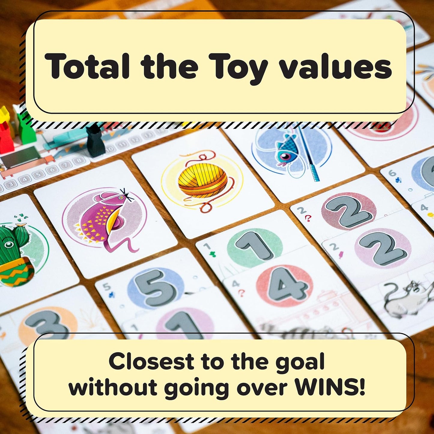 Tabletop view of a colorful card game showing toy illustrations and numbered cards (1-5) with gameplay instructions