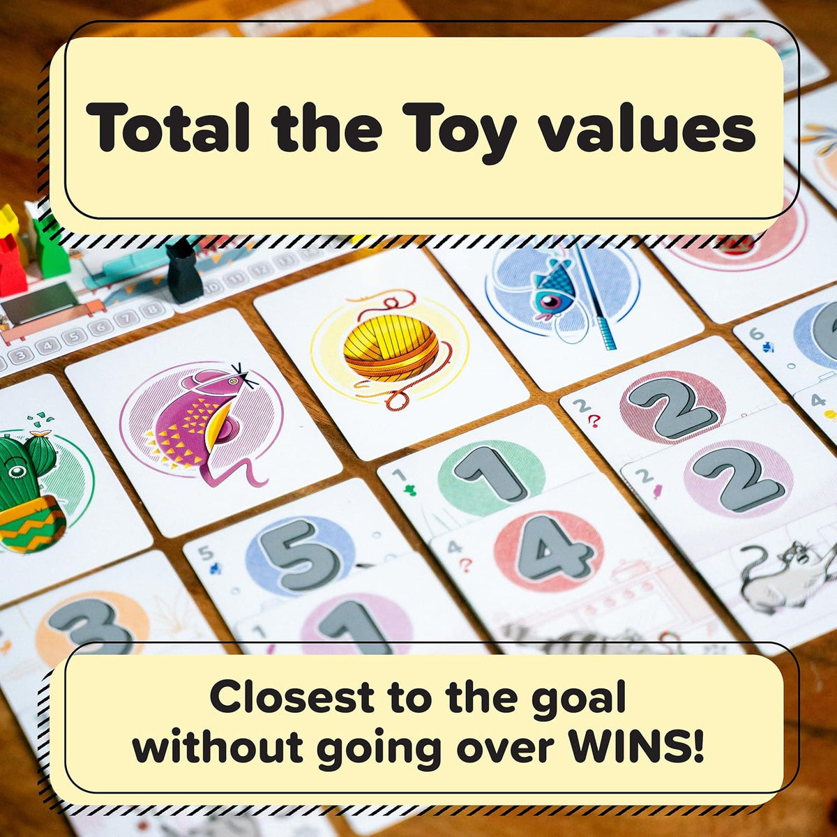 Tabletop view of a colorful card game showing toy illustrations and numbered cards (1-5) with gameplay instructions