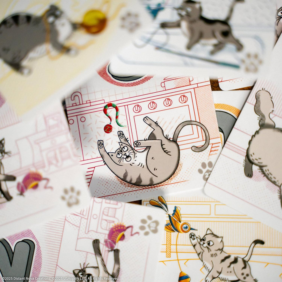 Close-up of illustrated game cards featuring playful cartoon cats