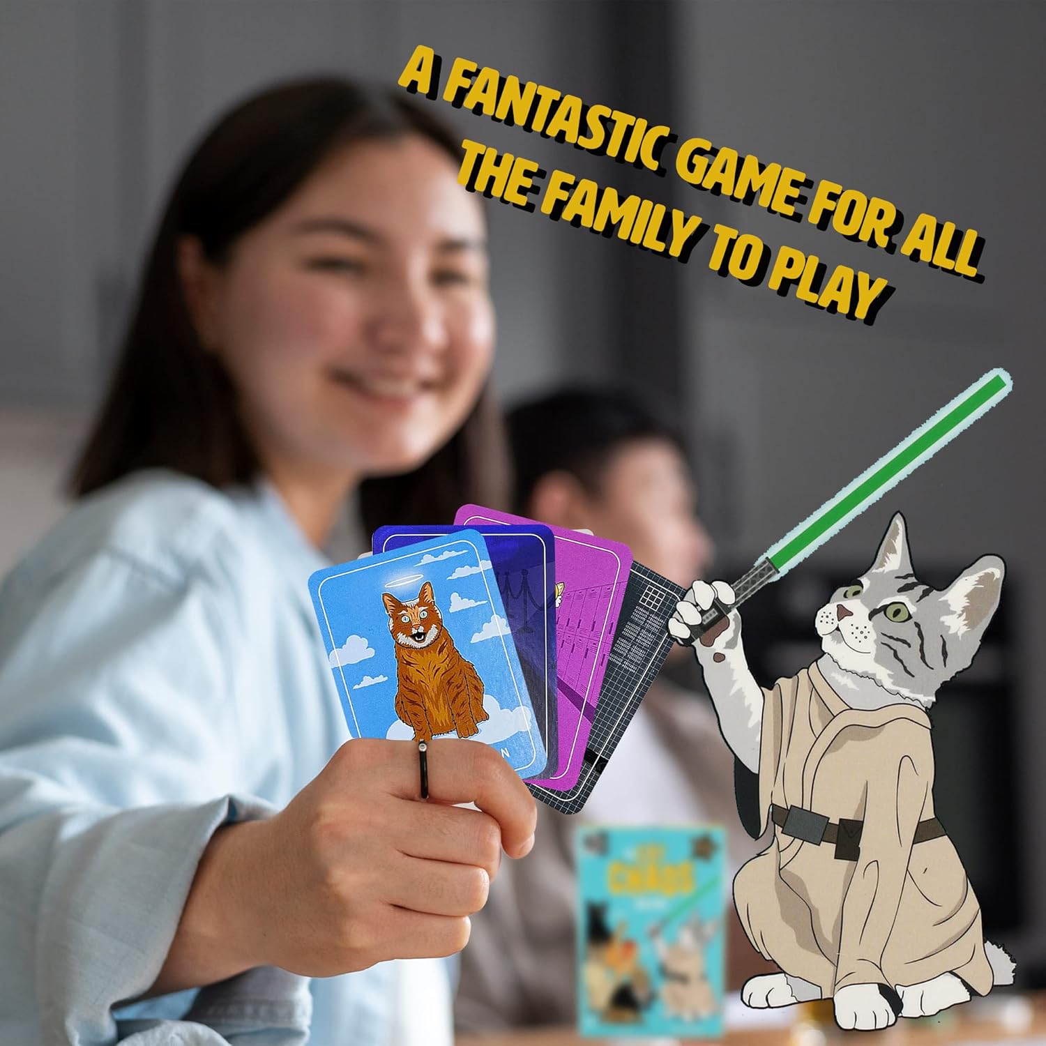 Smiling woman holds Cat Chaos game cards, with a cartoon Jedi cat holding a green lightsaber in the foreground