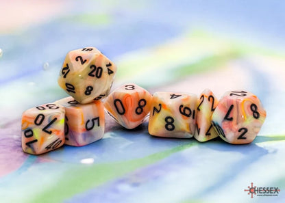 A cluster of swirled orange, yellow and white polyhedral dice with black numbers on a colorful, blurred background