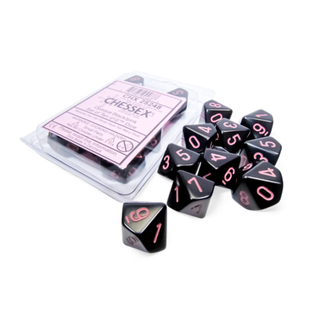 A set of black D10 dice with pink numbers, some scattered and some in clear plastic packaging