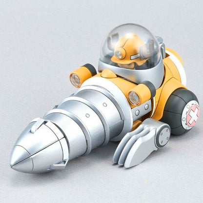 A yellow and silver mining drill bot. A pilot in a hard hat sits in its clear dome cockpit, with a large silver drill, lights and wheels