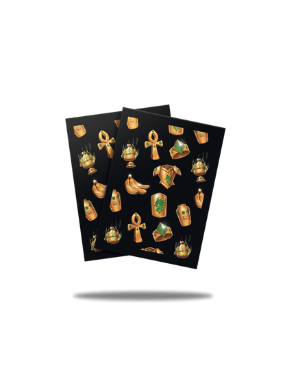 Two black cards covered in golden Egyptian treasure icons: ankhs, jewel rings, incense burners, armor pieces, and gold bananas