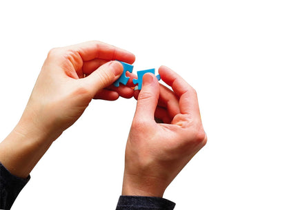 Two hands connecting two blue puzzle pieces against a white background