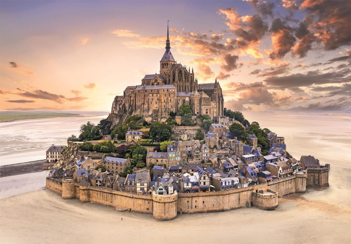 Mont Saint-Michel: Fortified island abbey and village at low tide, illuminated by a vivid sunset