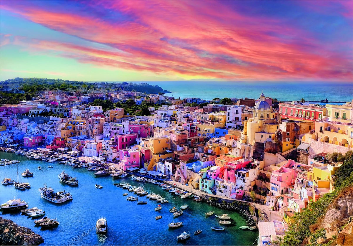 Puzzle shows aerial view of a vibrant coastal town with colorful houses, a busy harbor with boats, and a dramatic pink-orange sky