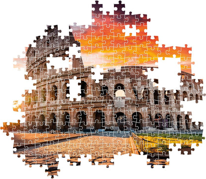 Partially assembled jigsaw puzzle of the Colosseum in Rome, against an orange sunset