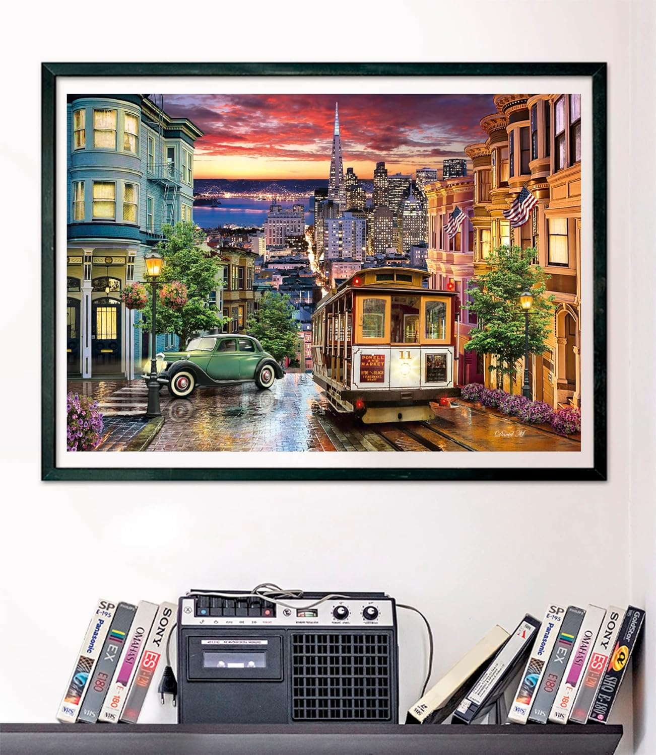 Framed San Francisco street puzzle: Cable car, vintage green car on wet street at sunset, flanked by historic buildings and a city skyline