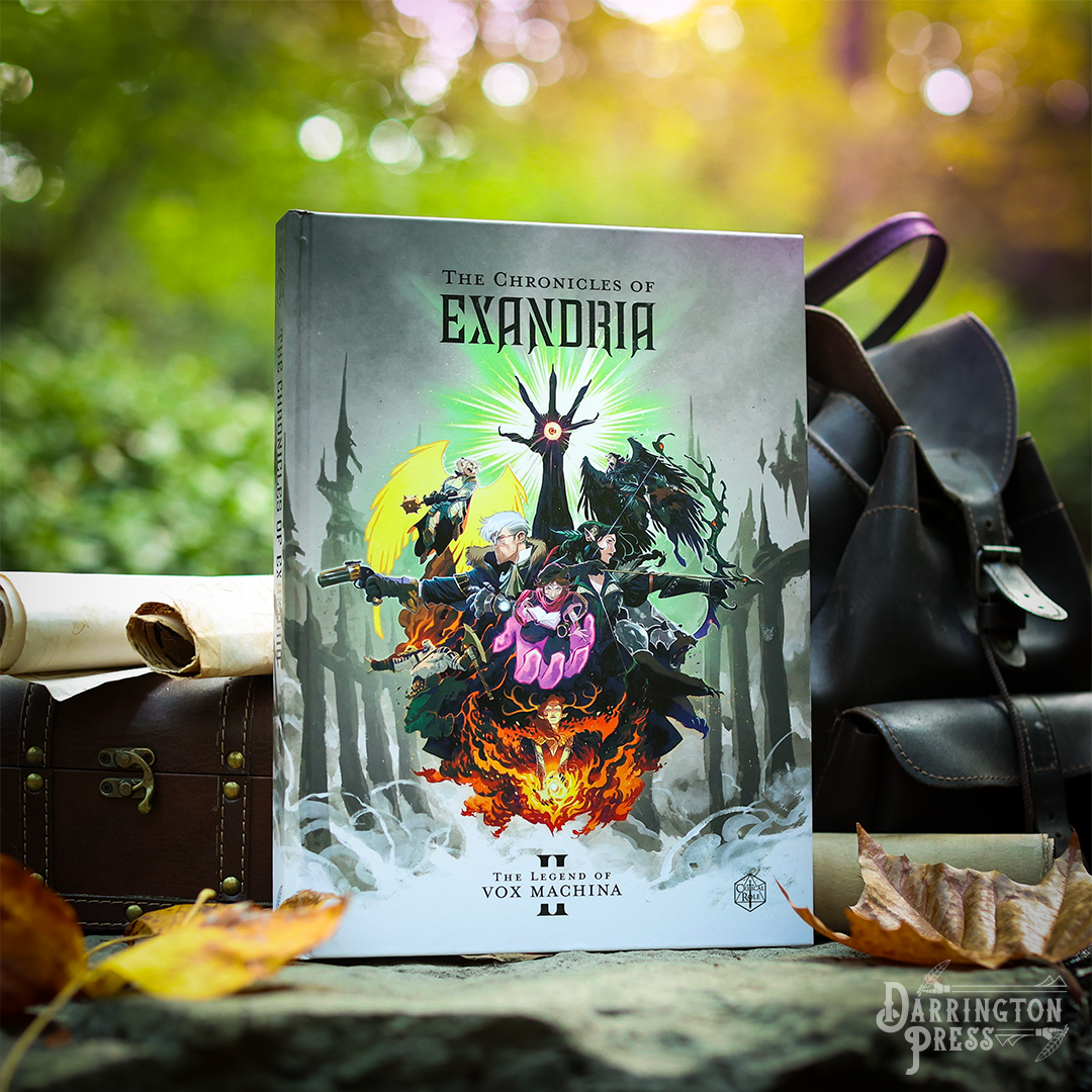 Fantasy book 'Chronicles of Exandria II' shows heroes, a glowing hand, and fire. Set outdoors with backpack and leaves