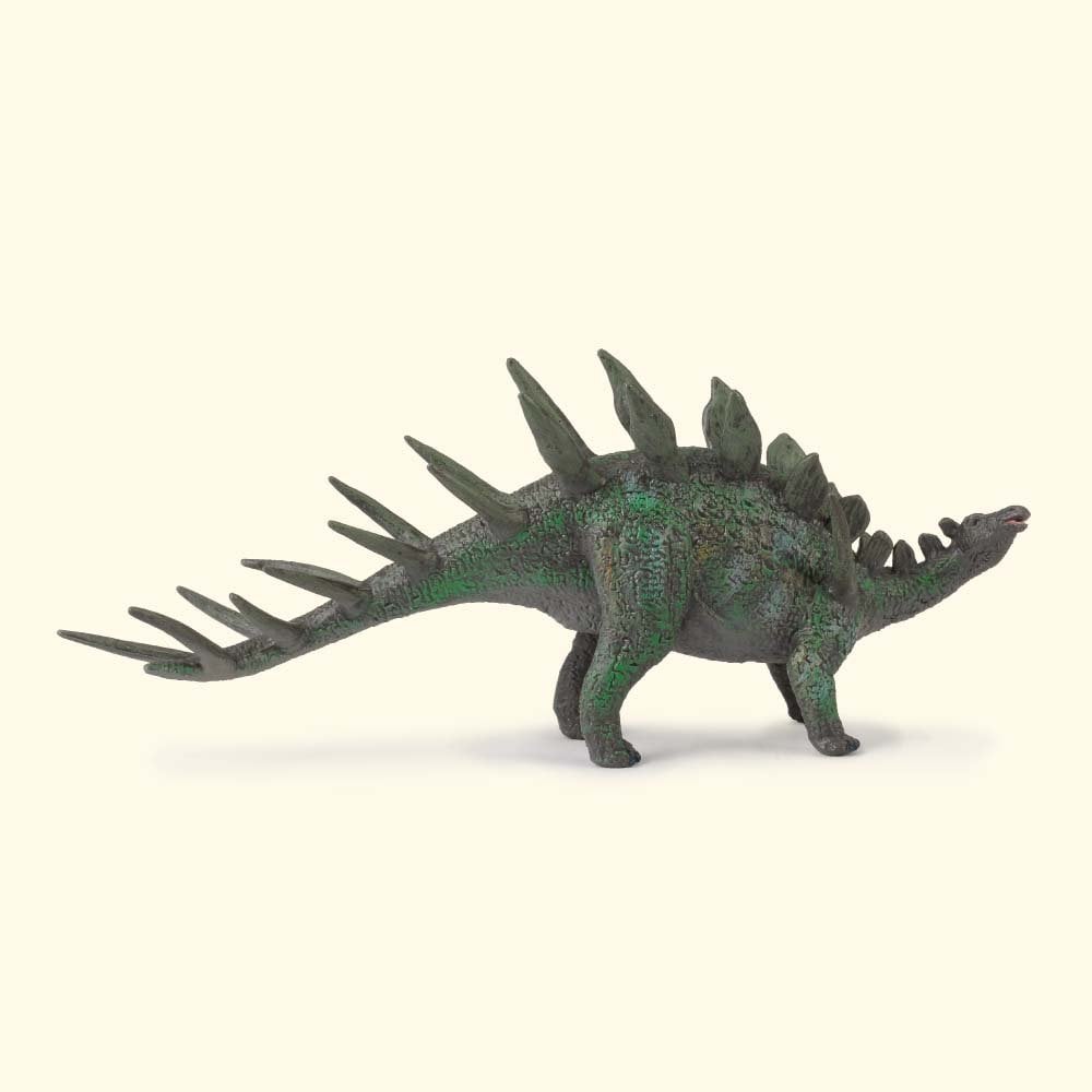 A green dinosaur toy with sharp spikes along its back and tail, standing