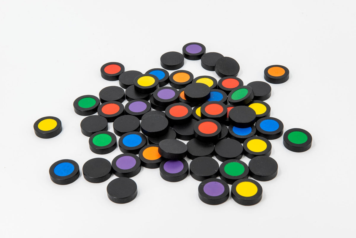 Colomo game setup showing vibrant colored wooden tiles arranged on a wooden board