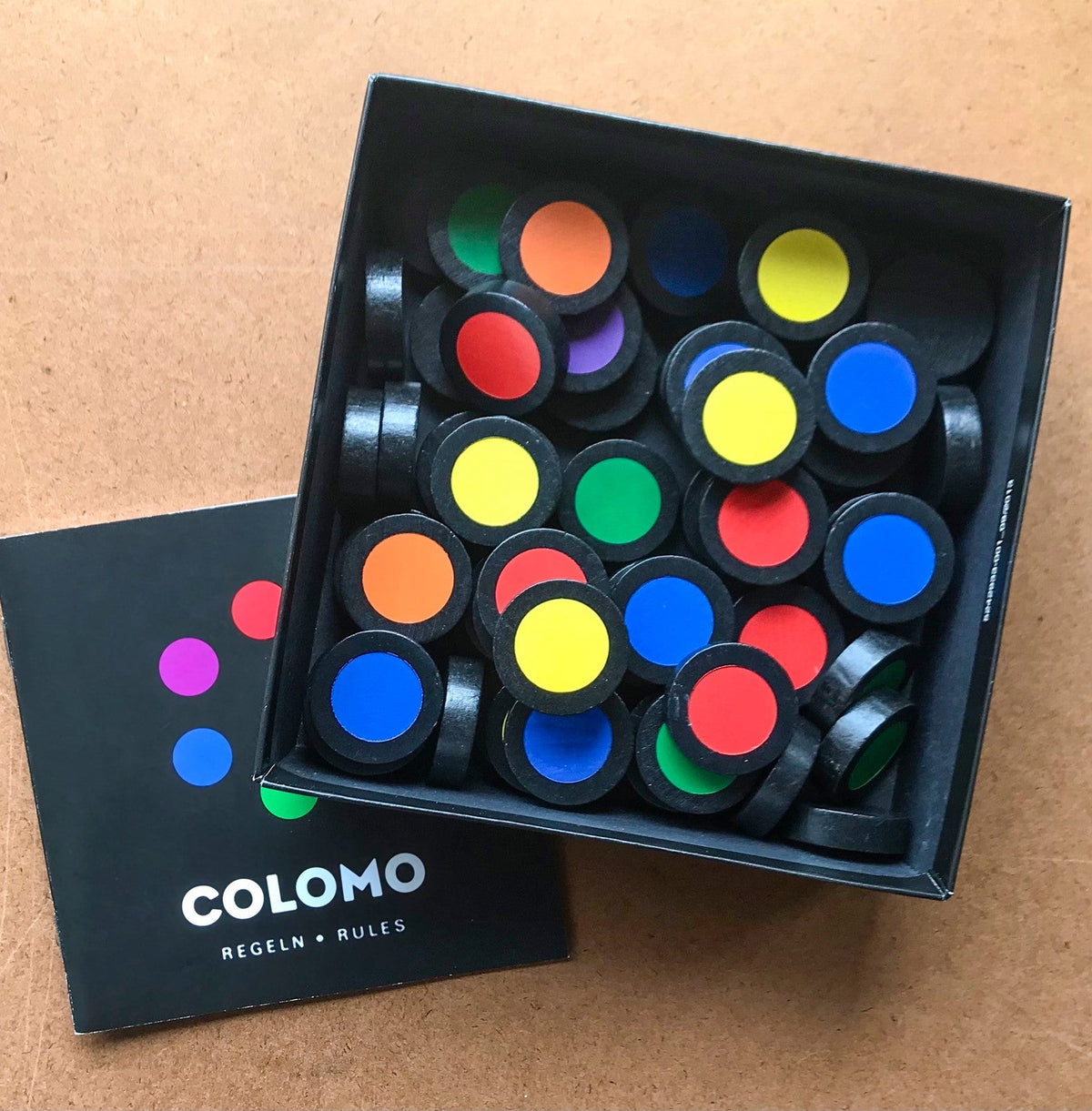 Colomo wooden game components laid out with a mix of brown and colored pieces on display