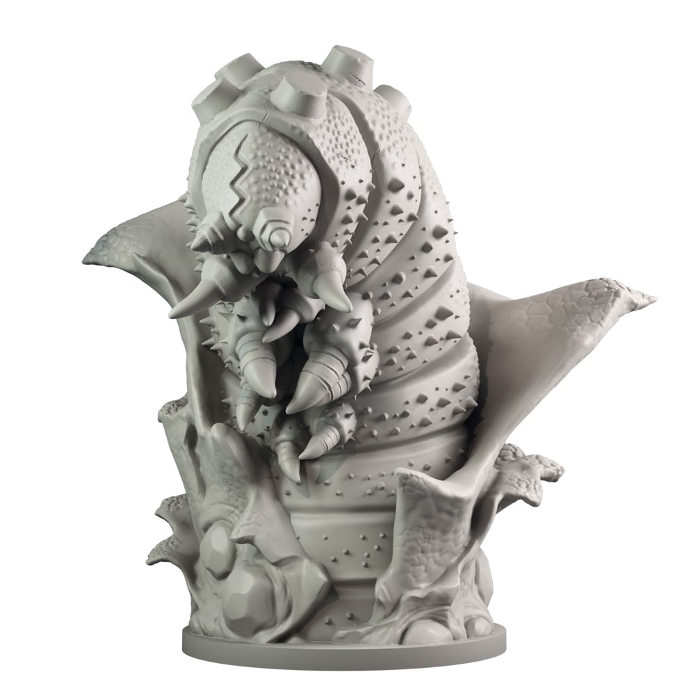 A grey unpainted miniature of a monstrous spiky grub-like creature with sharp mandibles rearing up