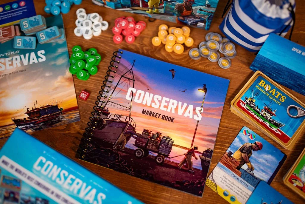 The Conservas board game components, including a rulebook with a fishing boat sunset scene, cards, and colorful tokens, are displayed on a wooden surface