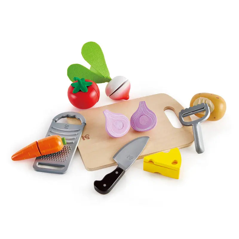 Wooden play kitchen set: cutting board, knife, grater, peeler, and toy vegetables & cheese, including a cut onion.