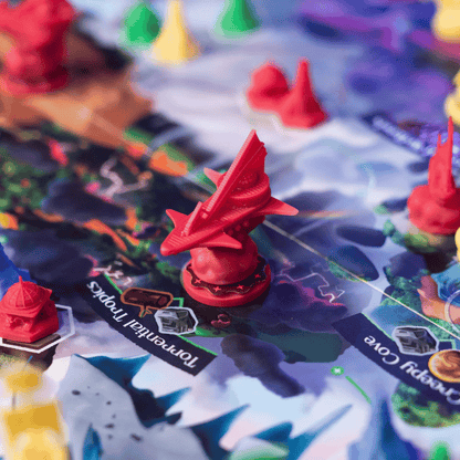 Detailed red plastic spaceship miniature token on a vibrant board game map with other conical pieces