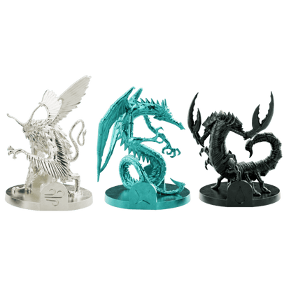 Three coloured fantasy miniatures: white winged creature, teal dragon, and black scorpion beast