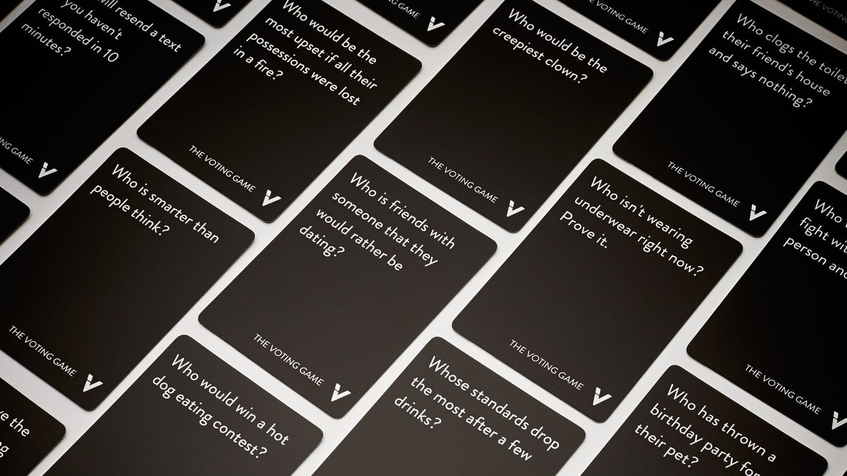 Black cards from The Voting Game with white text showing questions about group dynamics and personal preferences