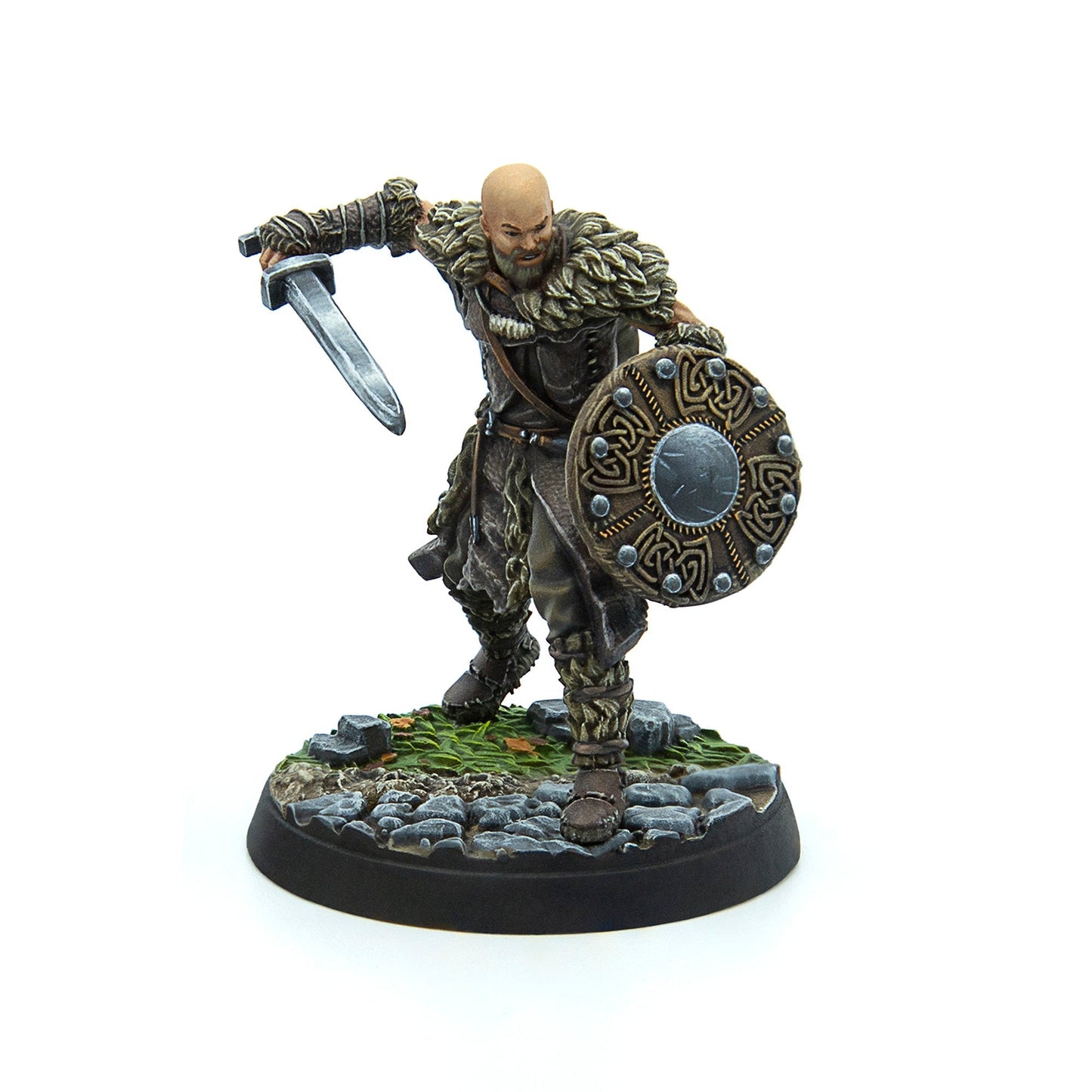 Miniature: Bald, bearded warrior in fur armor, wielding a sword and ornate Celtic shield in an action pose