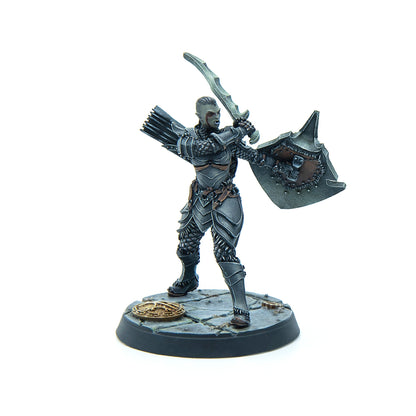 Miniature of an orc warrior in dark segmented armor, raising a sword and holding a shield, with a quiver of arrows