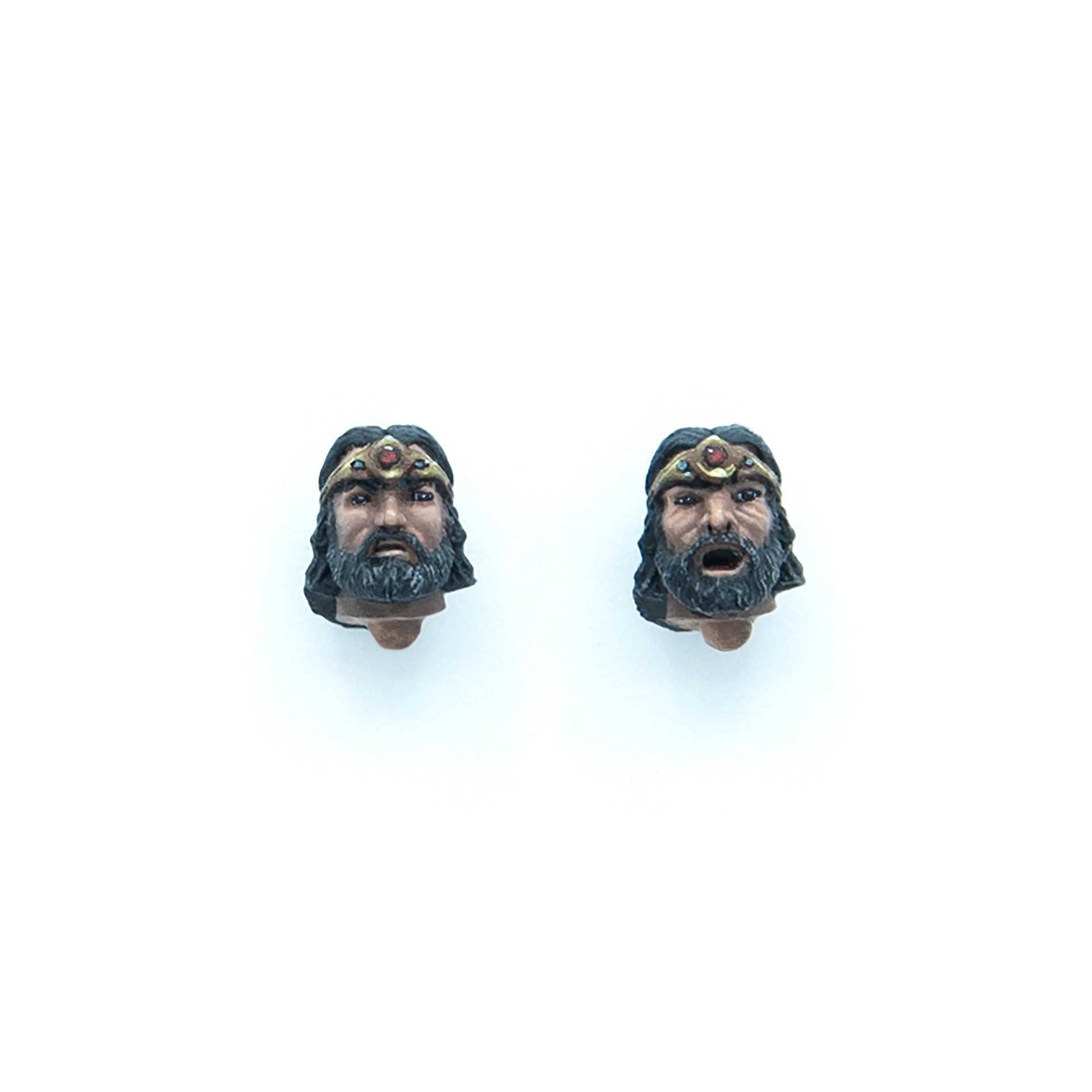 Two interchangeable action figure heads of a bearded man wearing a crown: one neutral, one with an open mouth