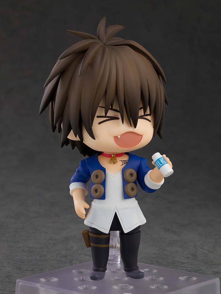 Close-up of Train smiling gently while holding a glass of milk in his left hand
