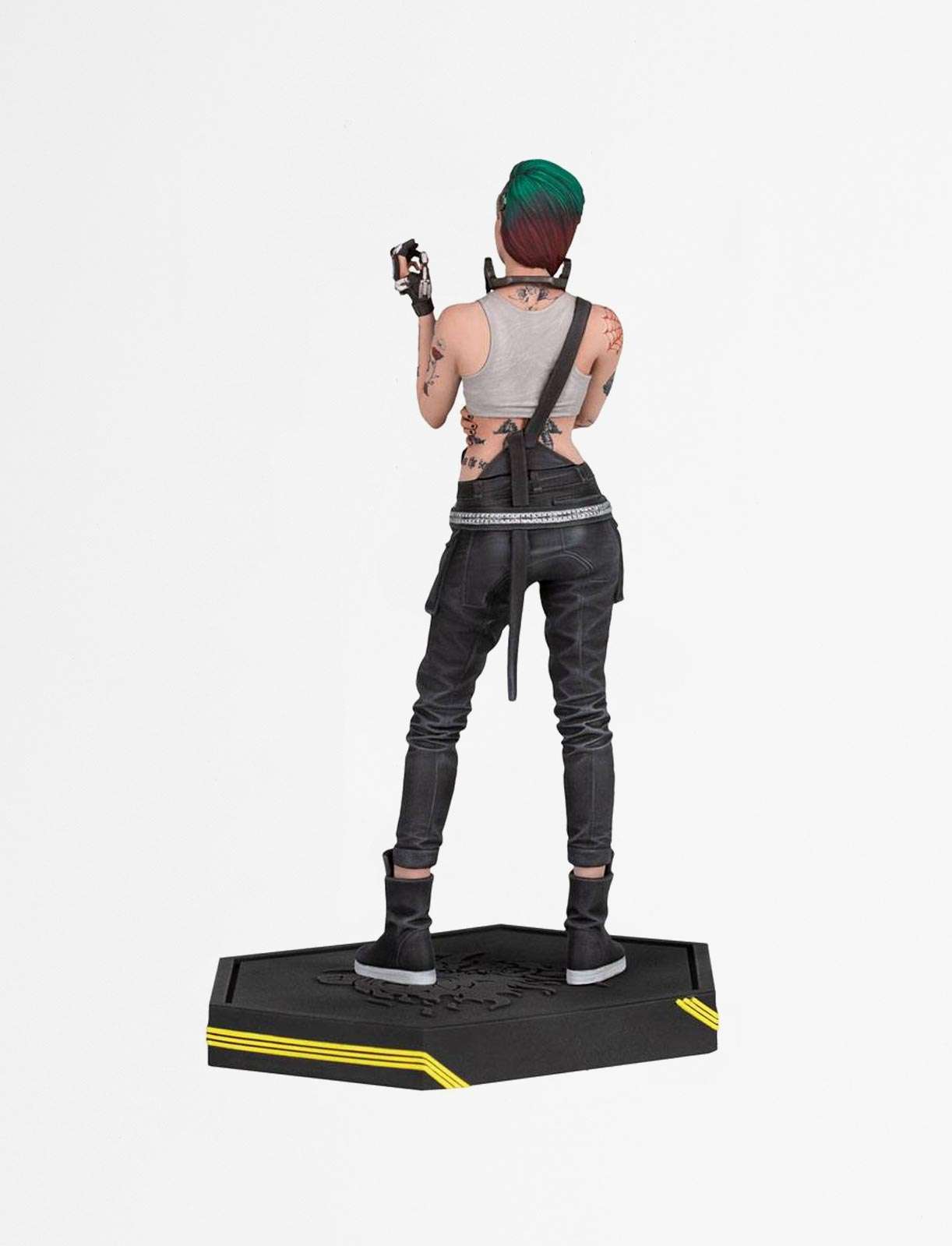 Back view of Judy Alvarez statue (Cyberpunk 2077) with green hair, tattoos, and metallic cybernetic hand, standing on a logo base