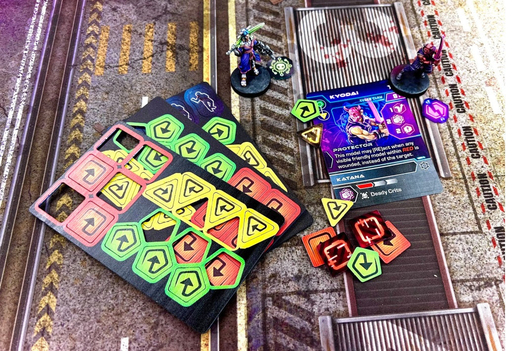 Two warrior miniatures, a character card and many colorful game tokens set on an industrial wargame board