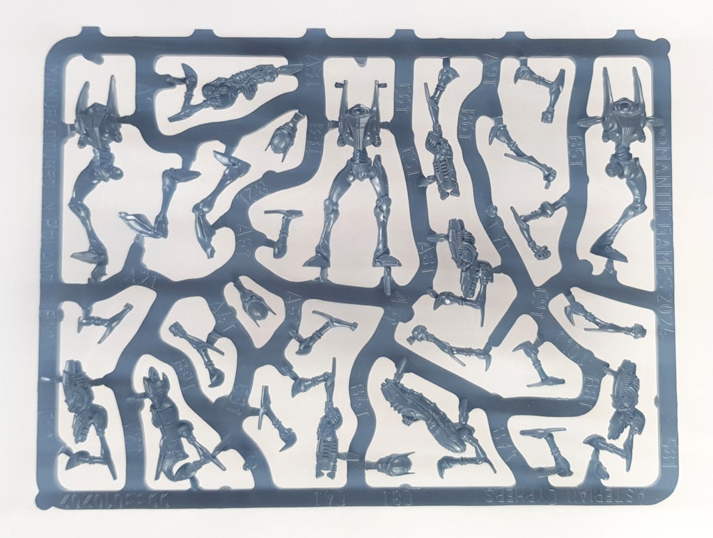 Grey plastic sprue holding unassembled sci-fi robot miniature parts, identified as Asterian Cyphers from Mantic Games