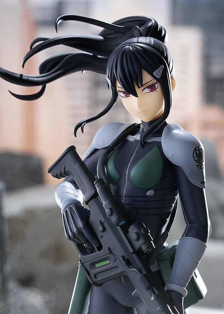 Rear view of the figure showing long flowing hair, holstered weapon on her back, and coat details