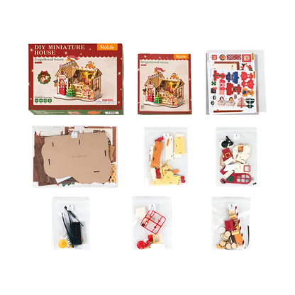 Rolife DIY Miniature Gingerbread House kit contents, showing the box, instructions, and nine bags of unassembled parts