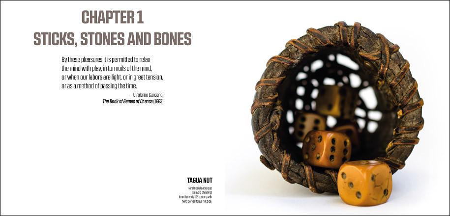 A worn brown leather dice cup is tipped, spilling several light brown tagua nut dice with dark pips onto a white surface