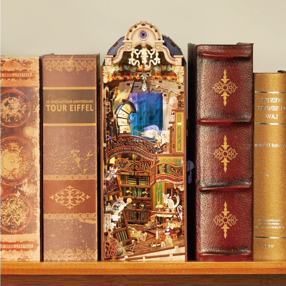 An illuminated, multi-level book nook diorama of a magical library scene, glowing between books on a wooden shelf